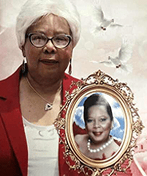 A woman in glasses and a red blazer holds a framed portrait of another woman in pearls, set against a soft, light background with white doves.
